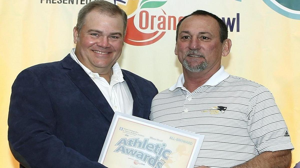 Boys Golf Coach of the Year Brandt Moser (American Heritage), right, accepts his award from Miami Herald sports writer George Richards during the Miami Herald’s annual All-Broward Athletic Awards breakfast presented by the Orange Bowl on Fri., May 22, 2015 at the Signature Grand in Davie.