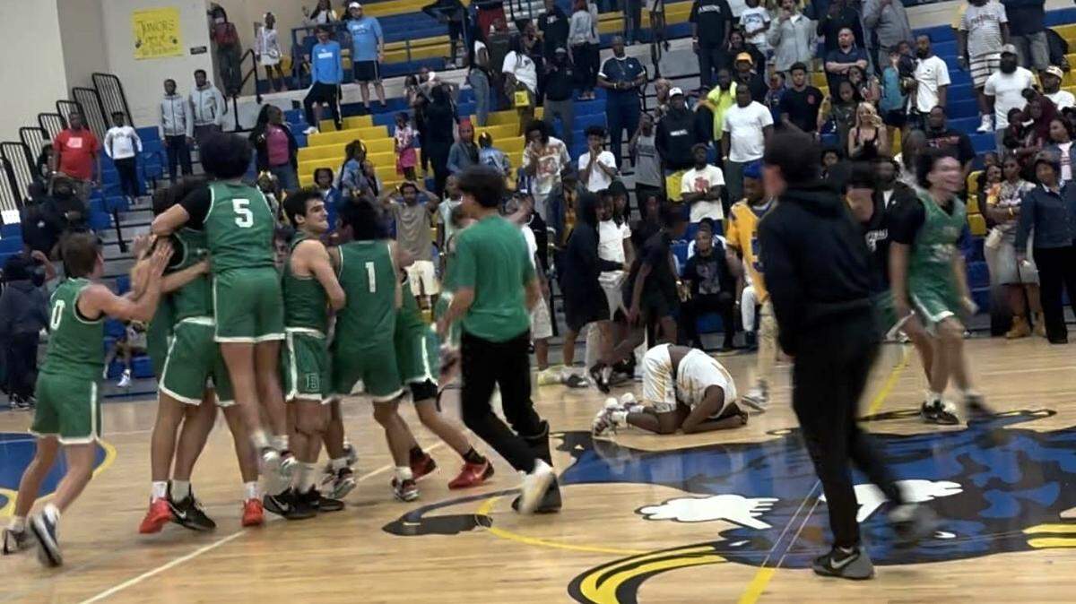 St. Brendan basketball celebrates beating top seeded Miami Northwestern in the Region 4-4A semifinal 70-69.