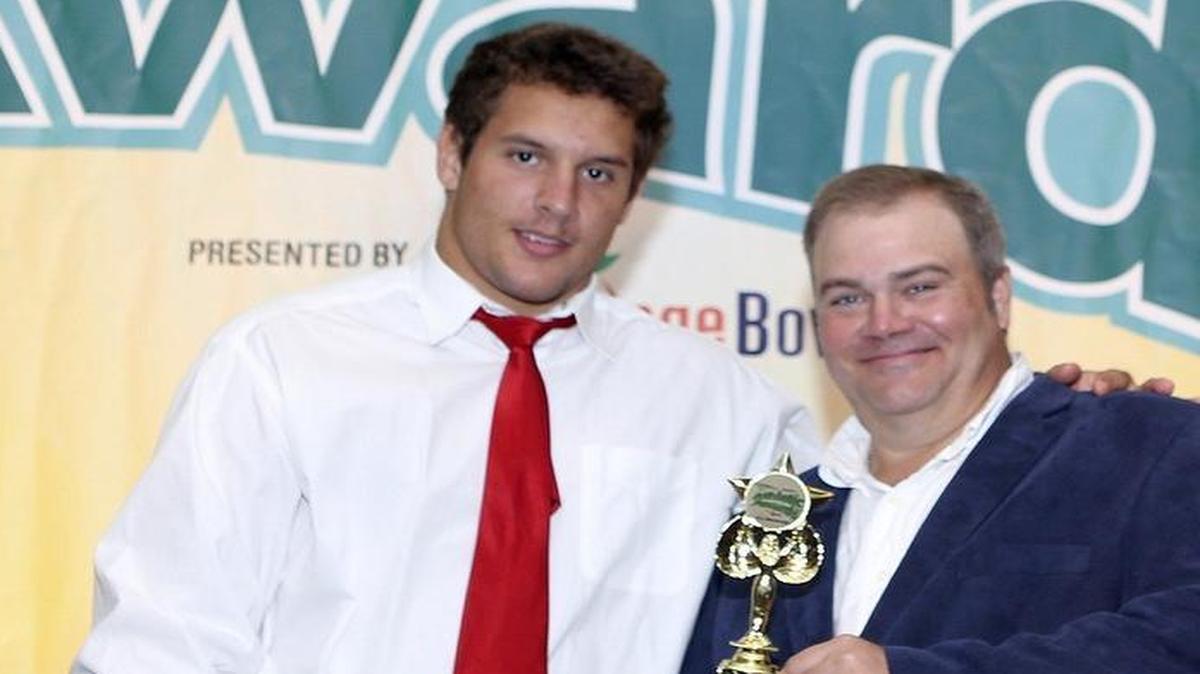 
Football 8A-6A Defensive Player of the Year Nick Bosa (St. Thomas Aquinas) accepts his award from Miami Herald sports writer George Richards during the Miami Herald’s All-Broward Athletic Awards breakfast Friday, May 22, 2015 at the Signature Grand in Davie.
