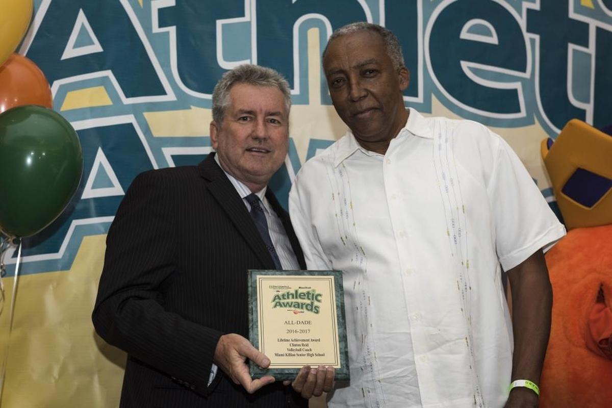 Miami Herald sportswriter Bill Daley presents Miami Killian Volleyball Coach Clinton Reid with the Lifetime Achievement Award at the Miami Herald Miami-Dade Student Athletic Awards Ceremony on Tues., May 23, 2017. Reid also won Miami-Dade Coach of the Year.