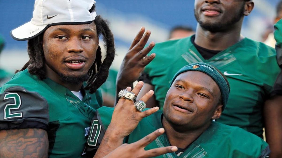 Donovan Thompson, left, and Peterson Joseph of Miami Central celebrate after defeating Seffner Armwood for the Class 6A title at the Citrus Bowl in Orlando on Saturday, December 12, 2015.