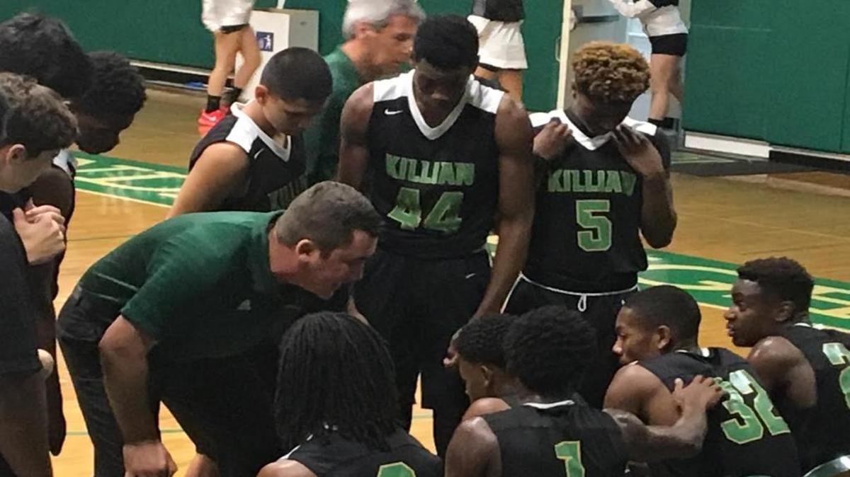 Killian boys’ basketball coach Austin Perez speaking to his players this season. Perez, 23, is the youngest coach in school history and one of the youngest in the state.