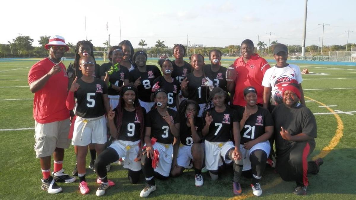 Members of the Edison girls flag football team celebrate their 20-0 victory over Jackson to claim the GMAC championship on Thursday afternoon at Traz Powell Stadium.