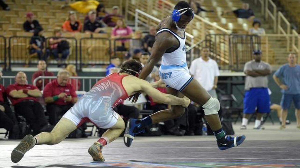 
Nino Sannasardo, left, of Cardinal Gibbons, tries to tackle Raekwon Reggler of Somerset Academy during the 182-pound final at the FHSAA State Wrestling Championships in Kissimmee, Fla., Saturday, March 14, 2015.
