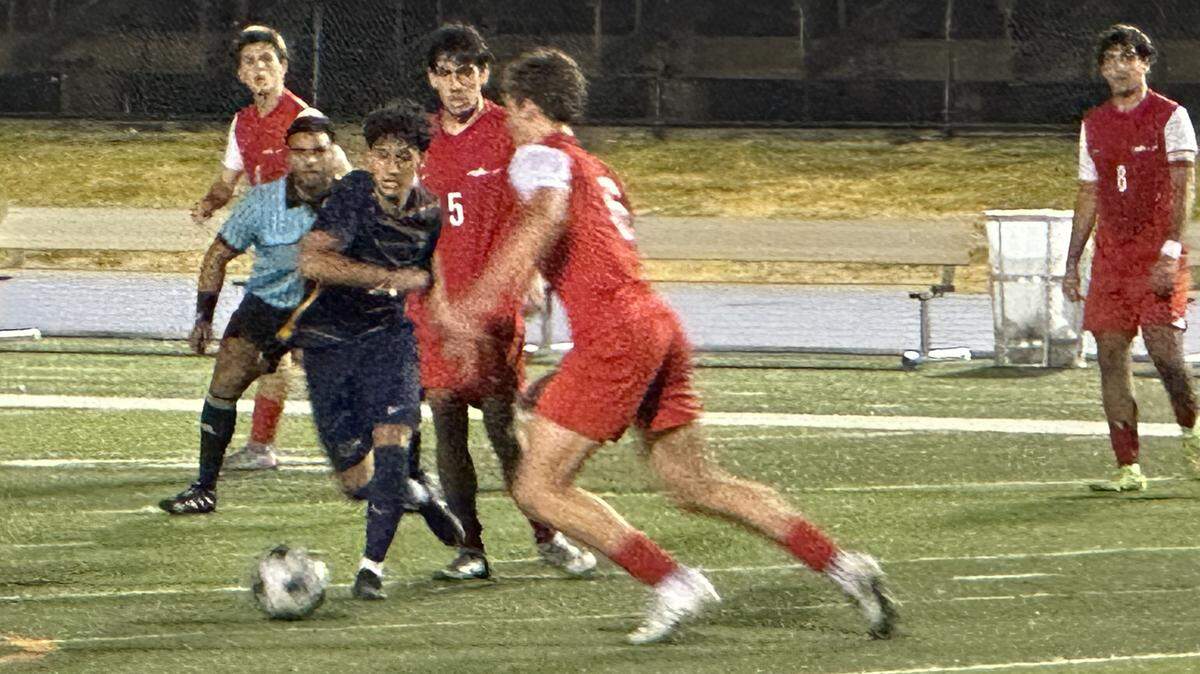 Downtown Doral’s Victor Villalobos (black jersey) battles through MAST’s defense on Tuesday during the Dolphins’ 4-0 win over the Makos in a Region 4-3A semifinal at Tropical Park.