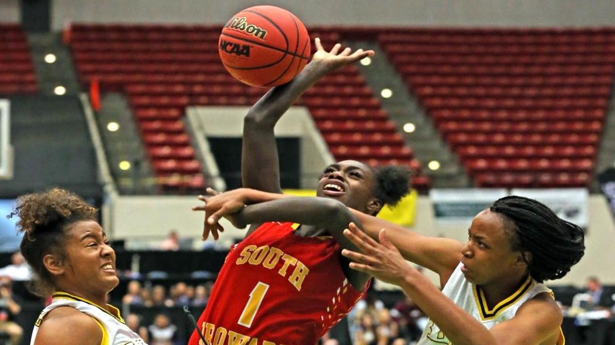 South Broward’s Rabiyah Bell is fouled by Winter Haven’s Diamond Battles, right, in the Class 8A title game.