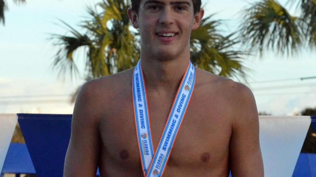 Belen Jesuit junior Aitor Fungairino stands on the medal stand with a first-place medal in the 200 freestyle at the FHSAA Class 3A state finals at Sailfiish Splashpark Aquatic Center on Friday (Nov. 4, 2016) in Stuart. Bill Kemp The Ledger