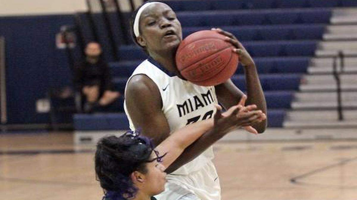 Miami High’s Beatrice Mompremier drives to the basket as Flanagan’s Jennifer Oramas holds her position during a girls’ regional semifinal game at Miami High on Tuesday, Feb. 10, 2015.
