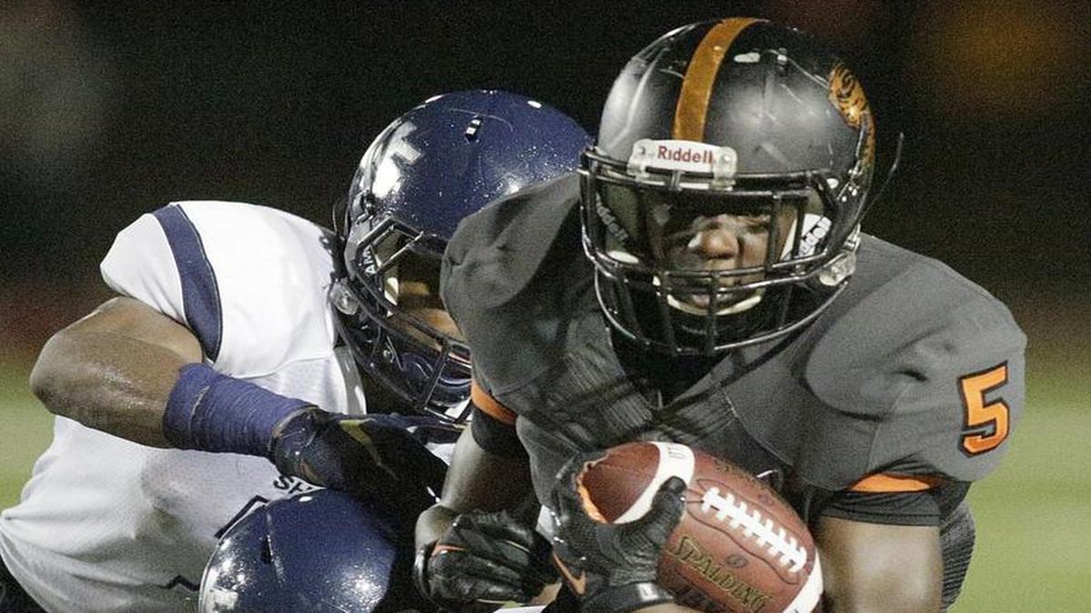 Booker T. Washington running back Trawone Johnson (5) runs with the ball during the football game against University School on Thursday, November 12, 2015 at Traz Powell Stadium in Miami.