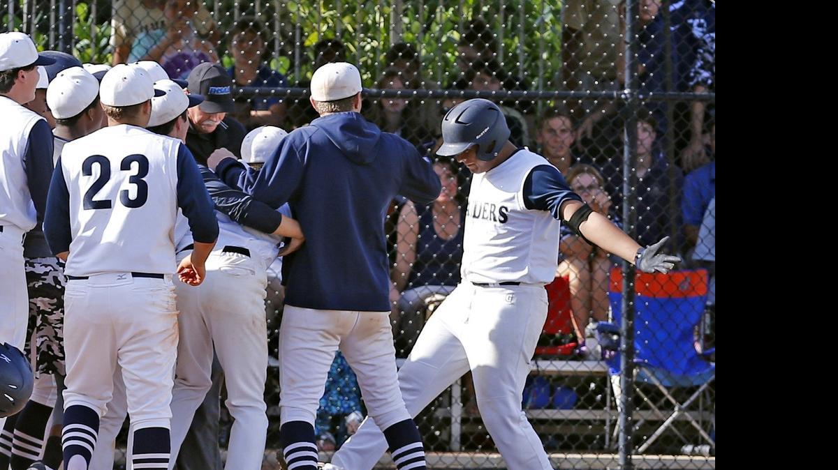 
Gulliver’s Gio Soto touches the base as his team greets him at home plate after a fourth-inning home run against visiting Calvary Christian in a regional final May 12, 2015.
