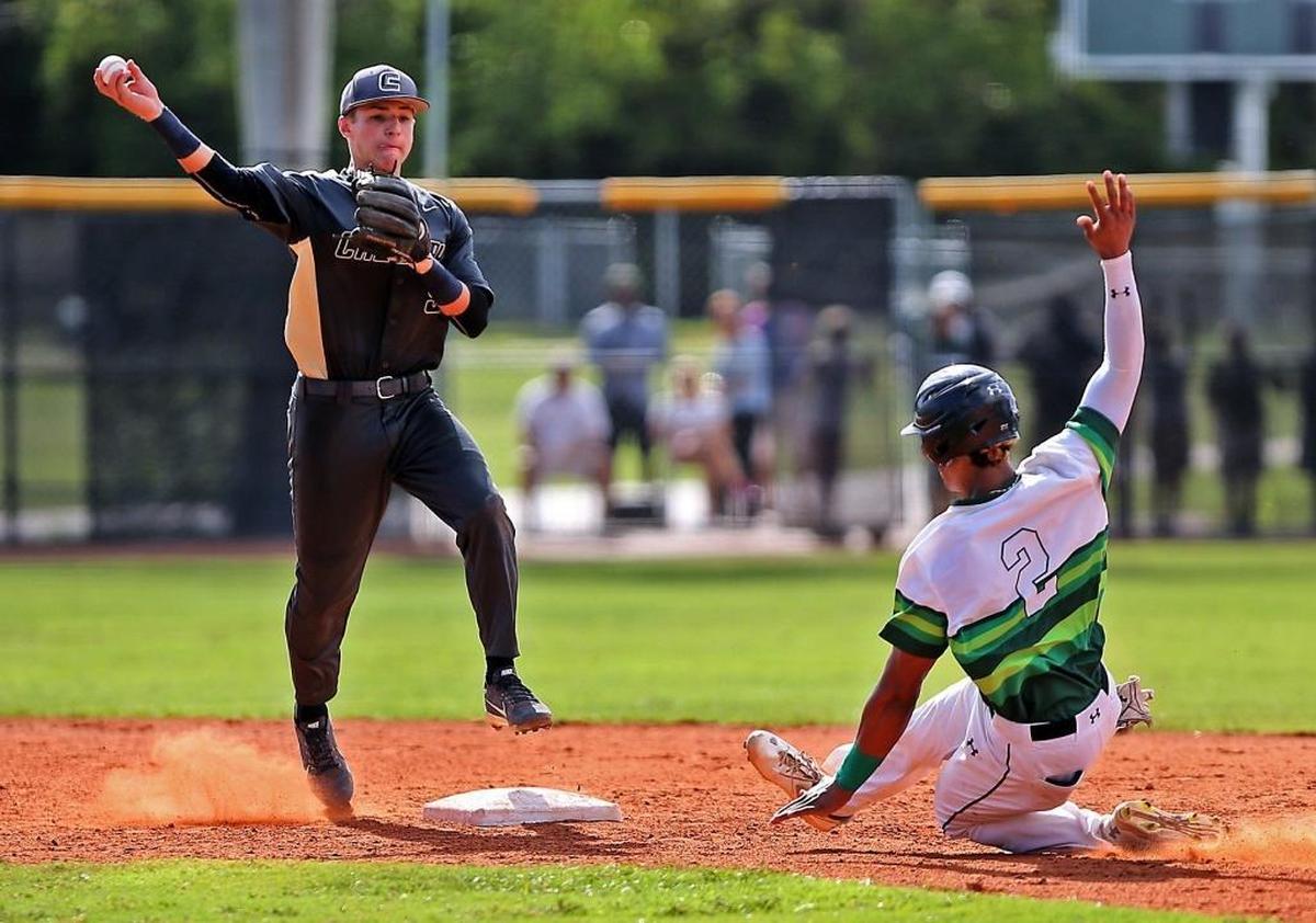 Calvary Christian's Dante Girardi, left, gets the force out on Westminster Christian's M.J. Melendez in the third inning as Westminster Christian hosted Calvary Christian in a baseball regional playoff on Tues., May 16, 2017.