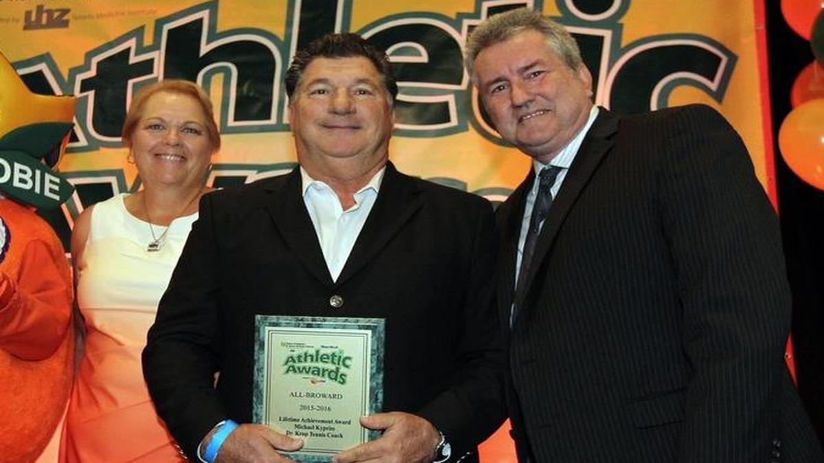 Mike Kypriss, middle, receives his Lifetime Achievement Award from Miami Herald correspondent Bill Daley, right, and Cheryl Golden, who also won a Lifetime award.
