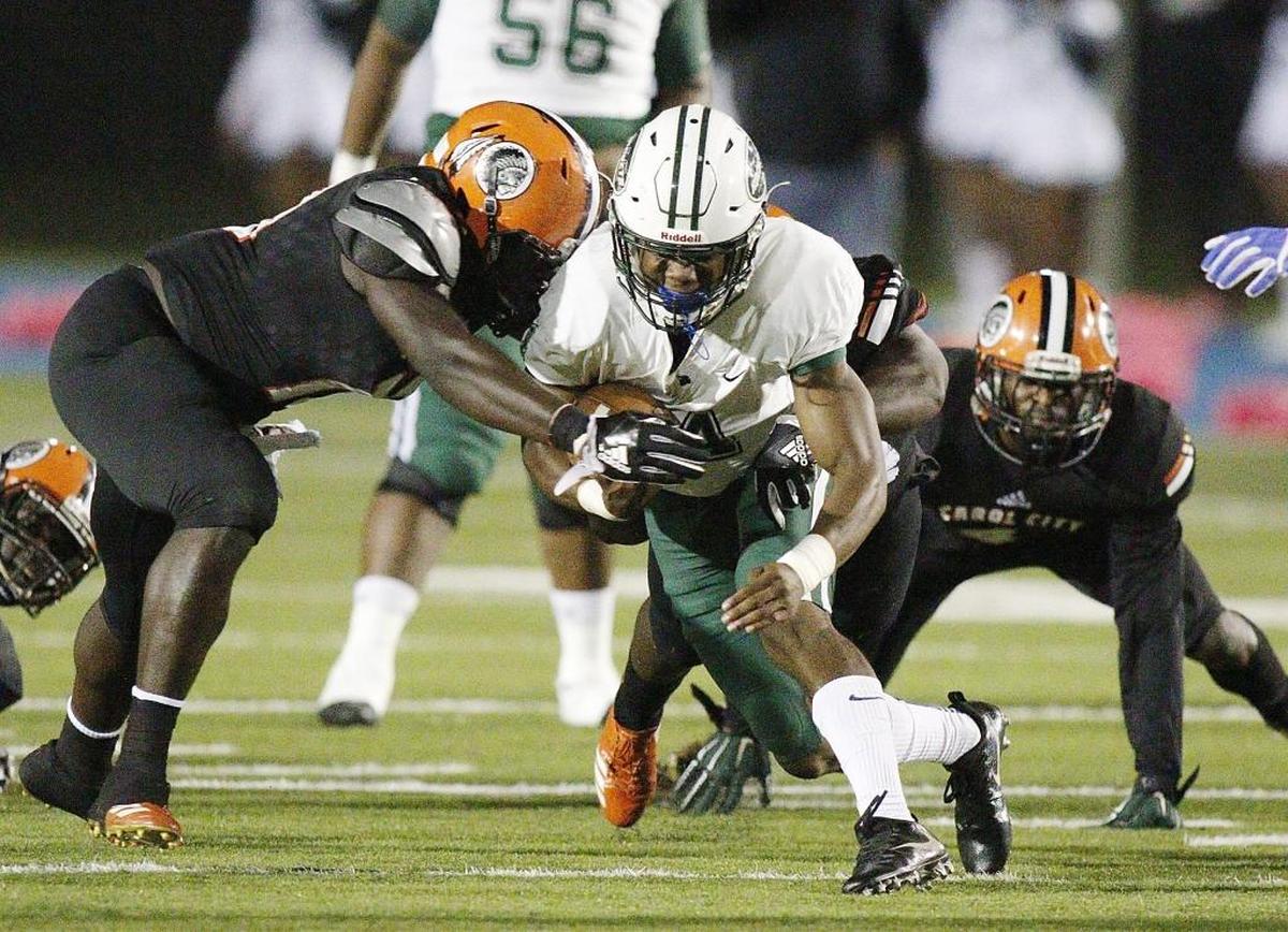 Miami Central Rockets' running back James Cook carries the ball against Carol City Chiefs during the football game on Fri., Oct. 27, 2017 at Traz Powell Stadium in Miami.