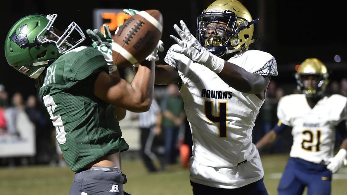 St. Thomas Aquinas’ Jaden Davis breaks up a pass play during the first quarter against Venice Indians wide receiver Jaivon Heiligh during the Class 7A state football semifinal at Powell-Davis Stadium on Friday in Venice.