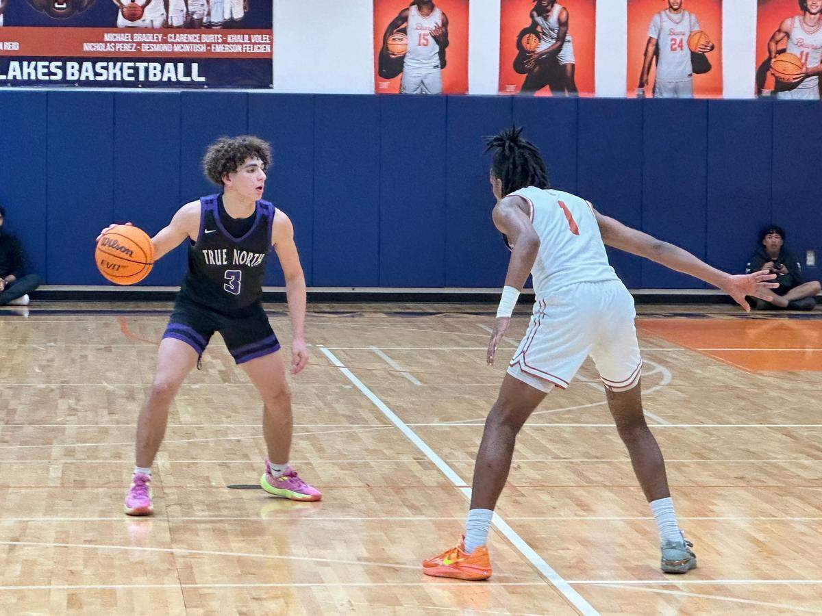 True North guard Jasen “J-Roc” Lopez surveys the court as Mater Lakes’ Clarence Burts defends during Thursday’s game between the two schools at Mater Lakes High.