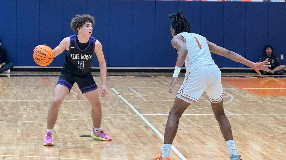 True North guard Jasen “J-Roc” Lopez surveys the court as Mater Lakes’ Clarence Burts defends during Thursday’s game between the two schools at Mater Lakes High.