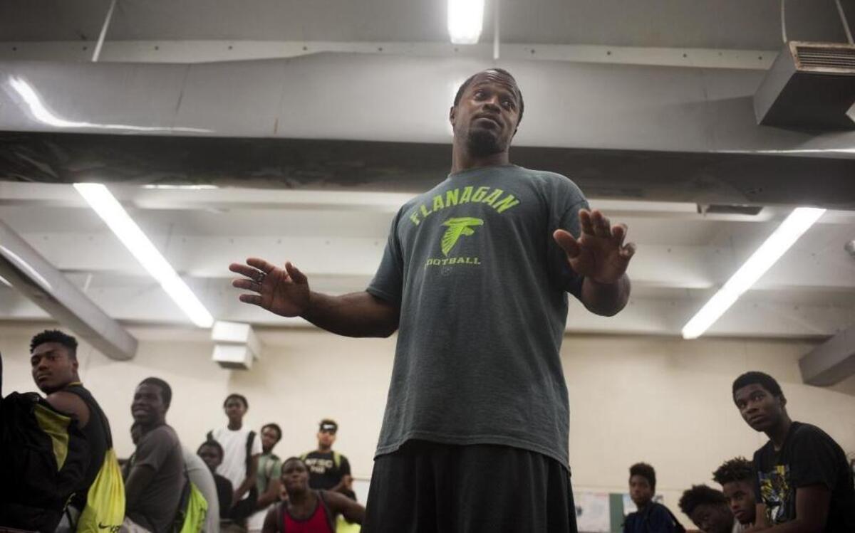 Flanagan high school head coach Stanford Samuel II talks to his team in t he locker room during the first practice of the high school football season at Flanagan High School on Mon., Aug. 1, 2016. The reigning state champions look to repeat again despite the loss of key players from last year.