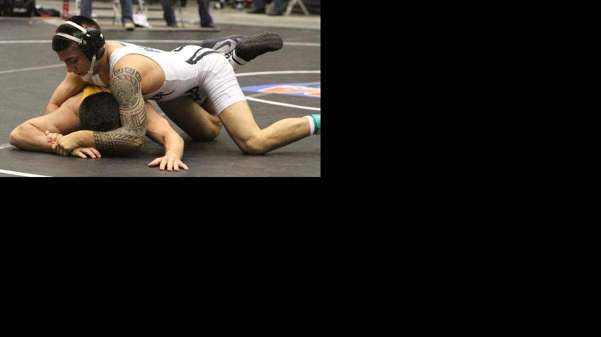 
South Dade’s Patricio Lugo, pictured during last year’s state championships, improved to 57-0 during the Region 4-3A wrestling finals Friday, March 6, 2015.

