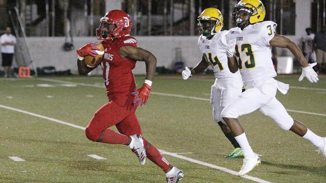 Doral Academy Firebirds' running back Kalonji Hill (21) runs to score a touch down against Nova Titans during the football game on Fri., Nov. 10, 2017 at Doral Academy in Doral.