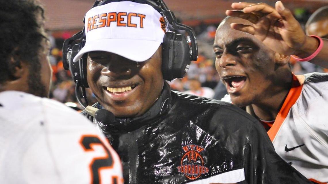 Booker T. Washington coach Tim Harris is doused with Gatorade as the team celebrates a win over Jacksonville Bolles for the Class 4A state championship Saturday, December 8, 2012 in Orlando, Florida.