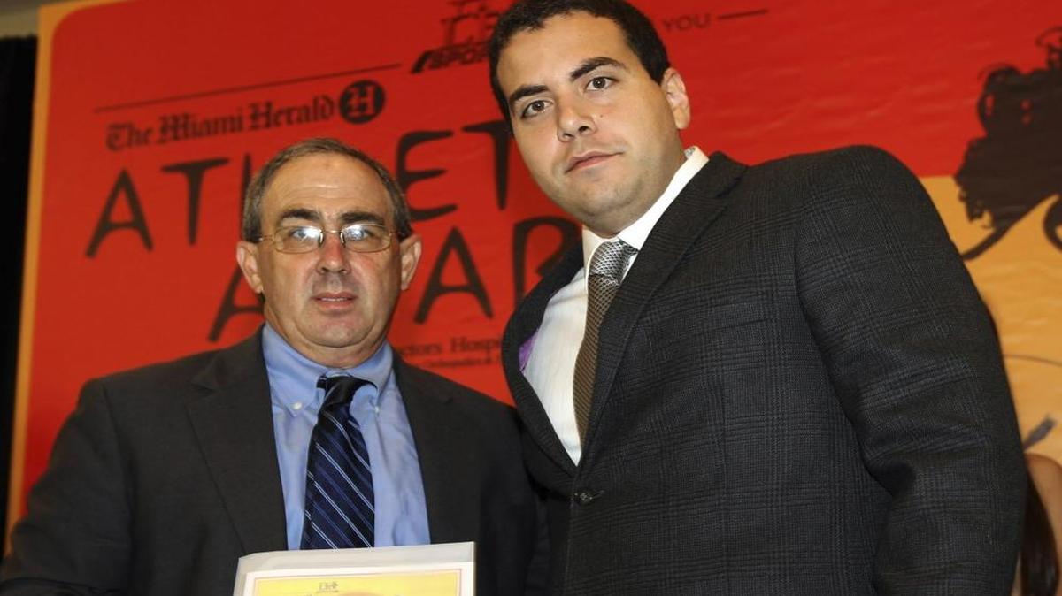Mark Schusterman, from gulliver, receives Softball coach of the year award 4A-1A, from Herald's Justin Azpiazu, at The Miami Herald Athletic Awards All-Dade 2010-2011, held at the Jungle Island on May 27, 2011