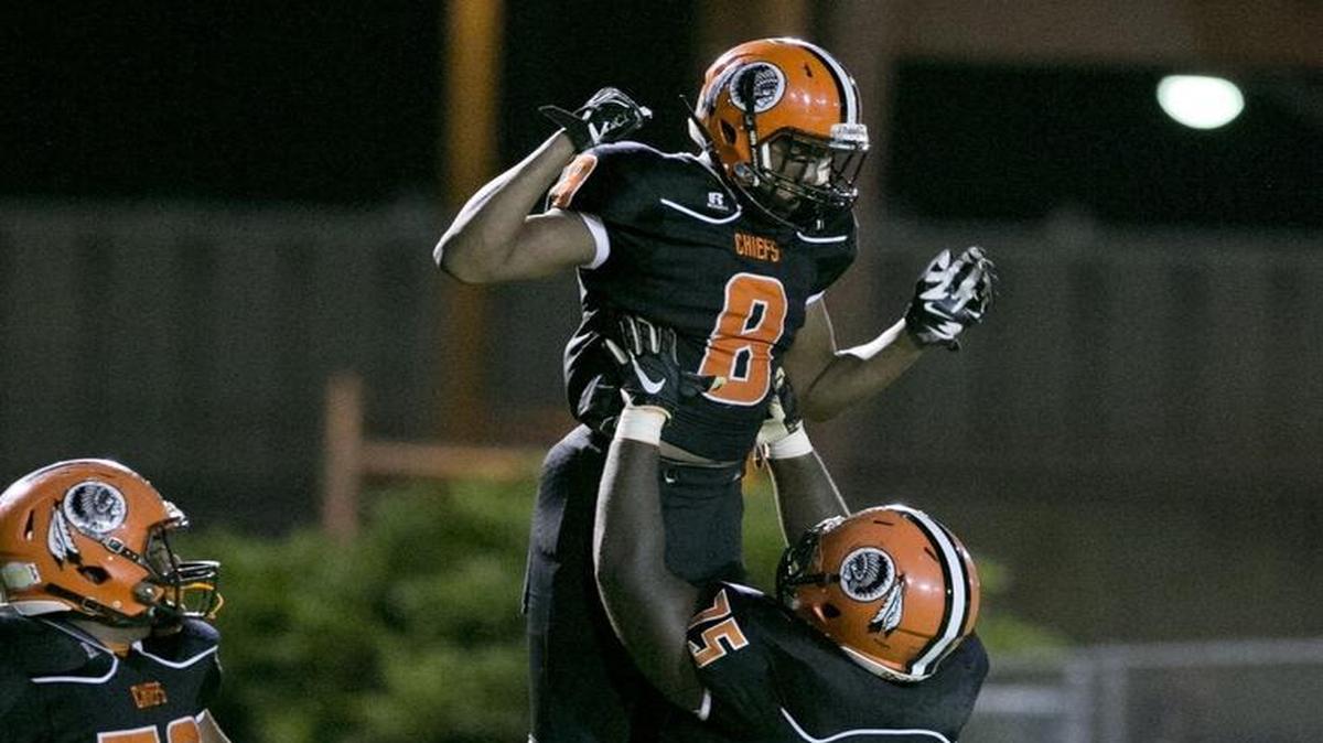 Carol City's Kevaughn Dingle, (8), and Dante Rose, (75), celebrate in the end zone after Dingle scores during high school football playoff game between Dillard High and Carol City High School at Traz Powell Stadium on Friday, November 13, 2015.