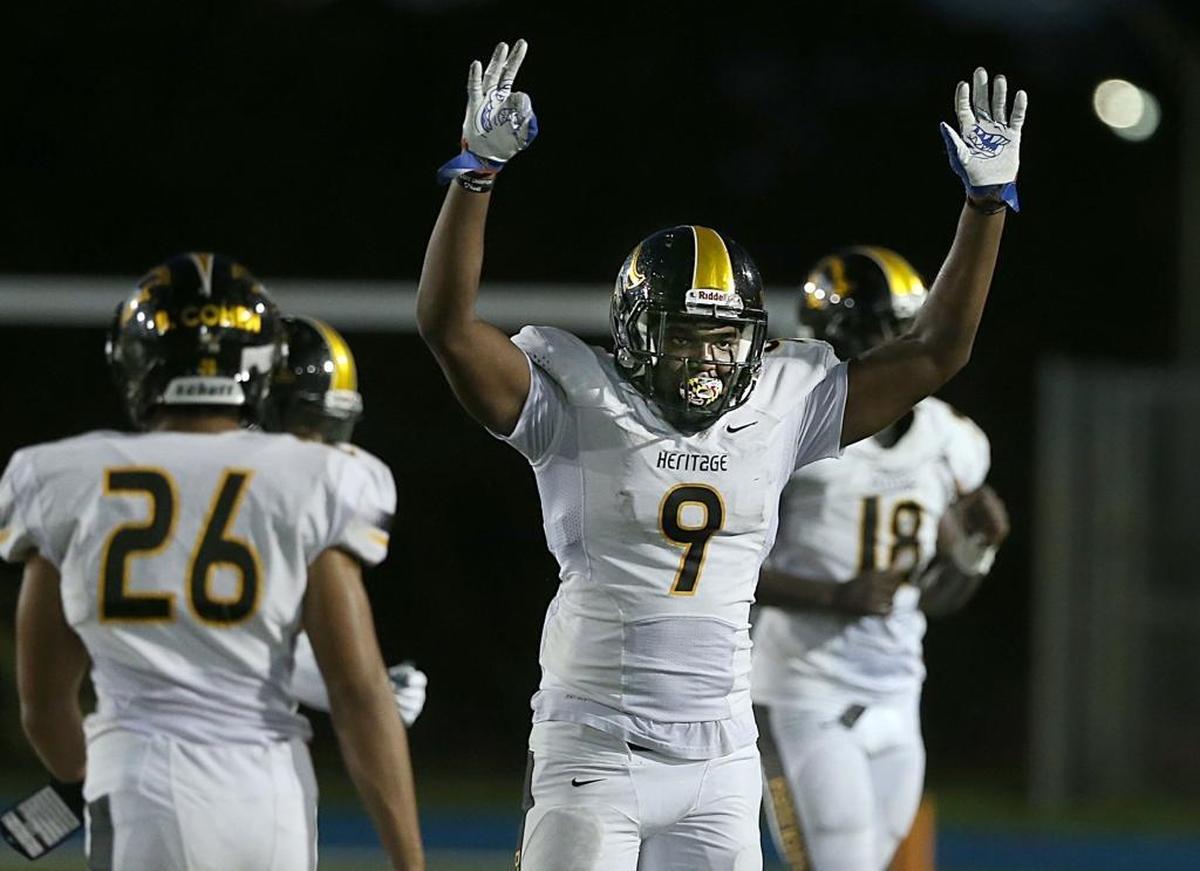 American Heritage defensive lineman Andrew Chatfield celebrates a touchdown against Booker T. Washington in the second quarter in a preseason clash of nationally-ranked teams at Traz Powell Stadium in North Miami on Friday, Aug.18, 2017.