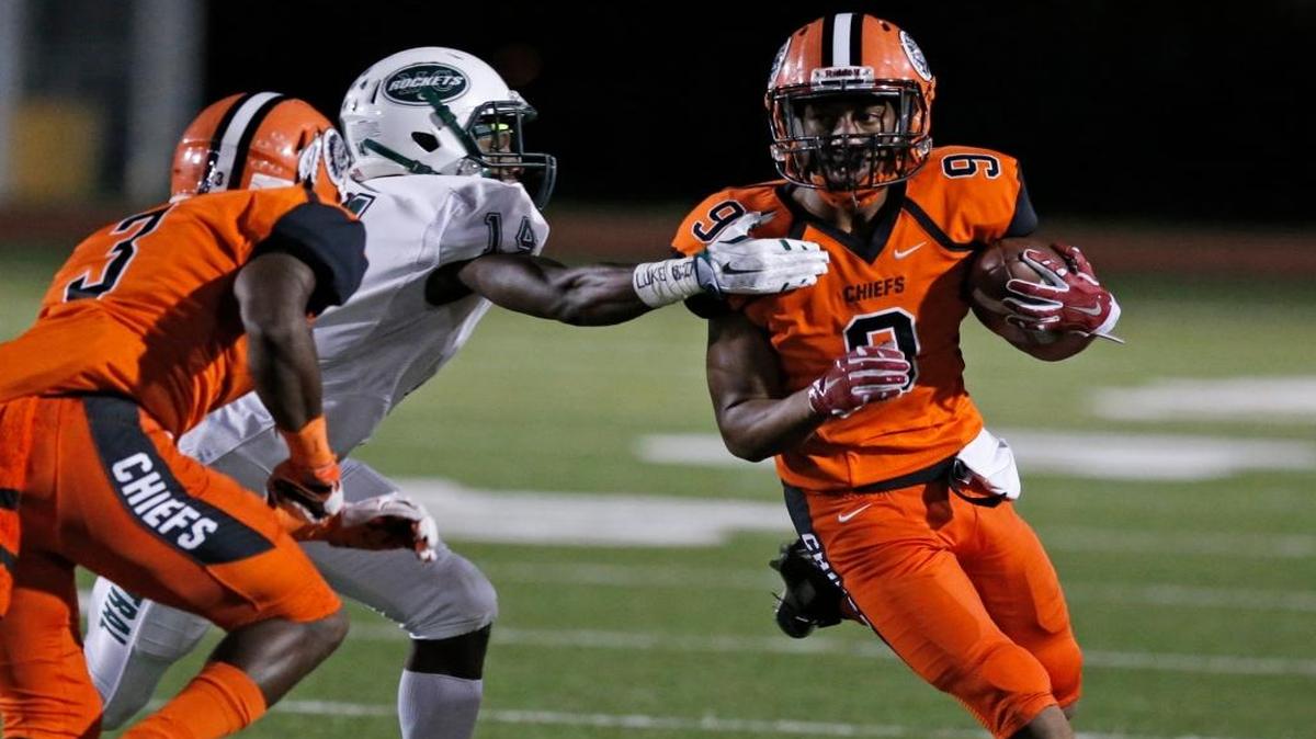 
Carol City wide receiver Victor Tucker runs as Central defensive back Allen Jones attempts to stop him on Saturday, October 3, 2015.
