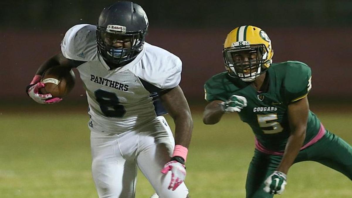 Palmetto’s Trey Flowers, left, tries to get away from Killian’s Kewan Smith during their game on Oct. 28, 2016. On Nov. 3, 2016, Flowers helped the Panthers defeat Ferguson 28-15.