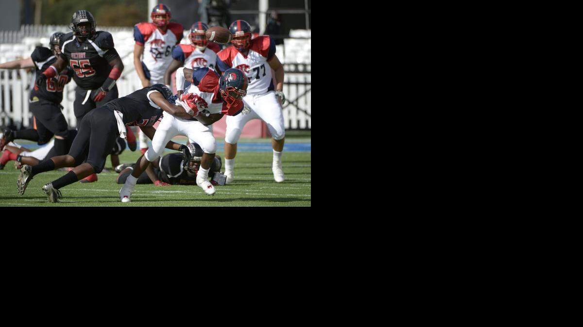 
Champagnat running back Michael Fredrick (8) fumbles the ball after being hit by Victory Christian's Antwain Locke, left, during the first half of the FHSAA Football Class 2A Finals in Orlando on Friday, Dec. 6, 2013.
