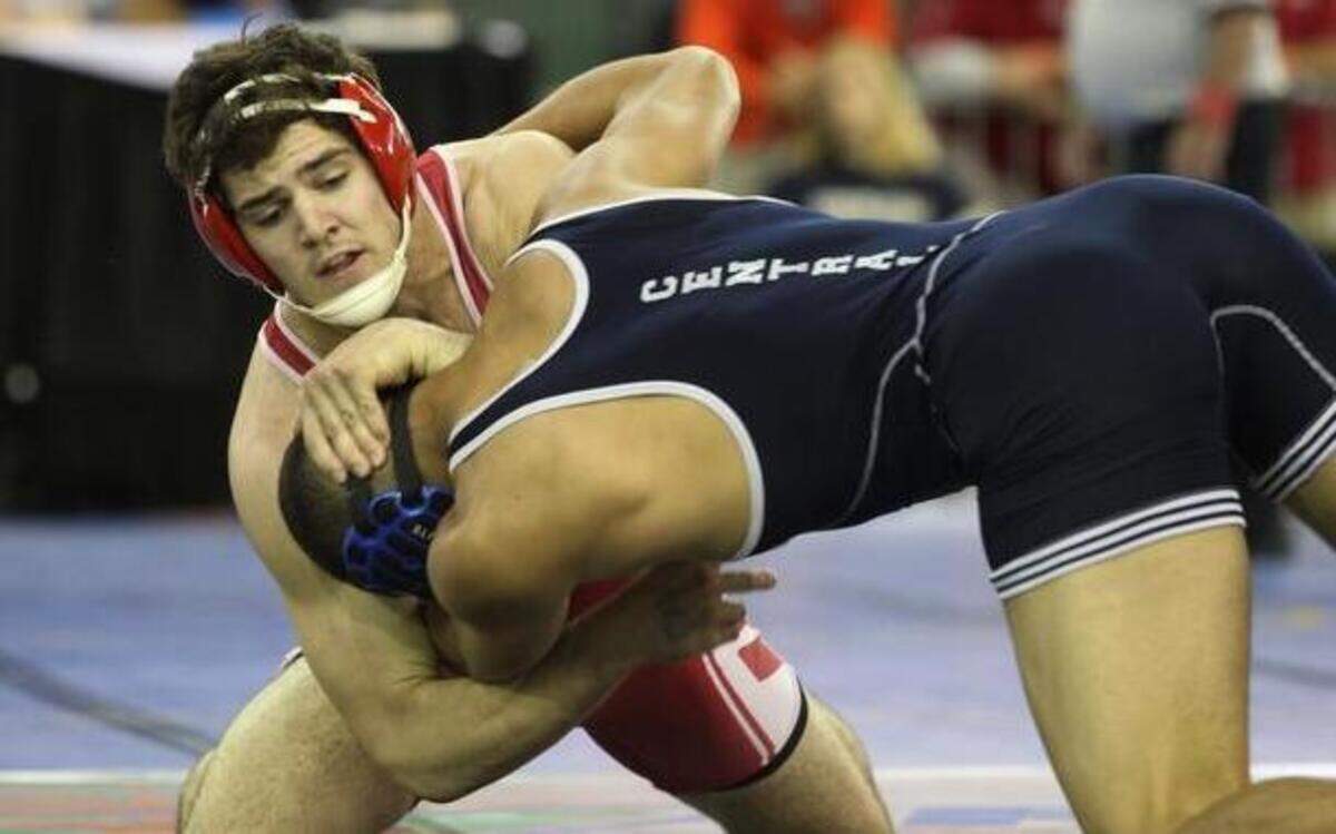 
Cardinal Gibbons’ Nino Sannasardo, left, defeats John Templar of Central on his way to the semifinals in the 182-pound weight class.

