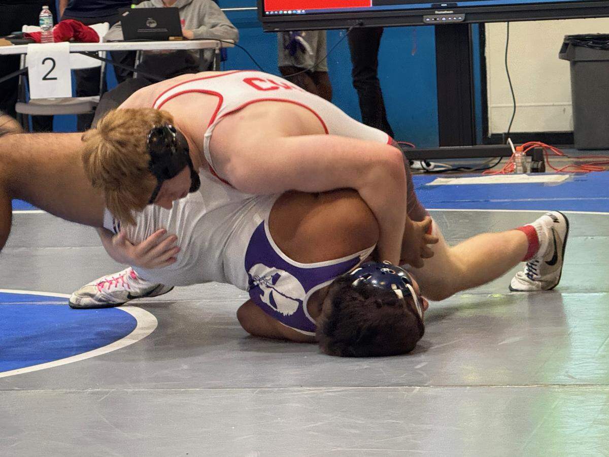 Cardinal Gibbons’ Michael Mocco (top) wins the BCAA title at 215 pounds on Saturday at Dillard High School in Fort Lauderdale.