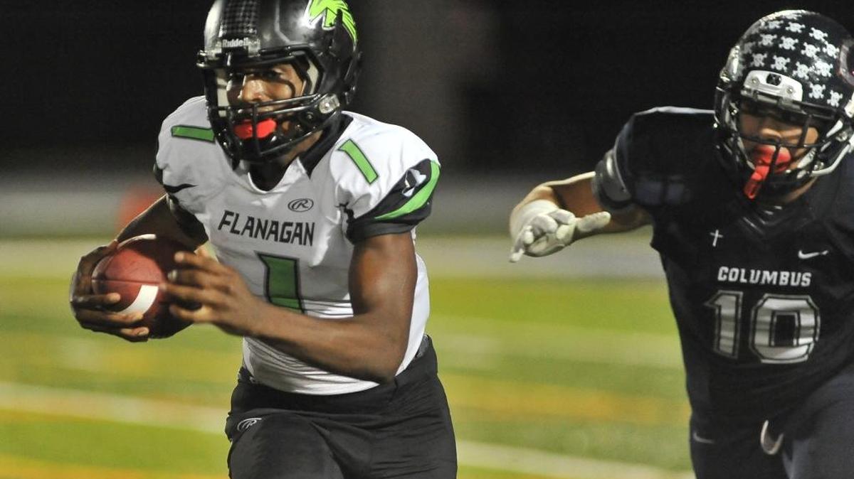 Flanagan Kalyn Nelson rushes for yardage during the second half of a high school football game. Columbus Explorers take on the Flanagan Falcons in a high school football game at Tropical Park, Friday night, Dec. 4, 2015 the Falcon beat the Explorers.