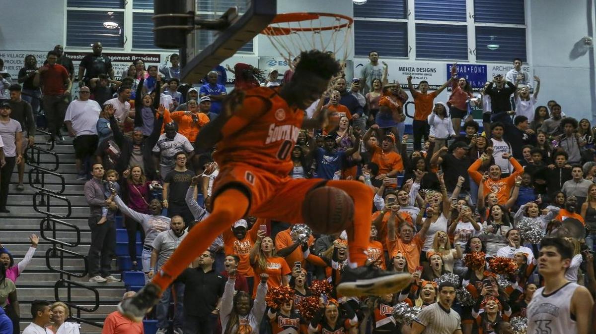 South Miami's Ezacuras Dawson (0) dunks against Palmetto during the fourth quarter of a boys' basketball playoff game in Miami Palmetto High School on Tues., Feb. 21, 2017. South Miami defeated Palmetto 58-52.