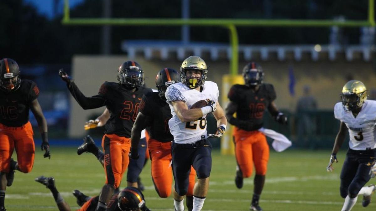 St. Thomas Aquinas running back Michael Epstein gets loose against Booker T. Washington at Traz Powell Stadium on Friday.