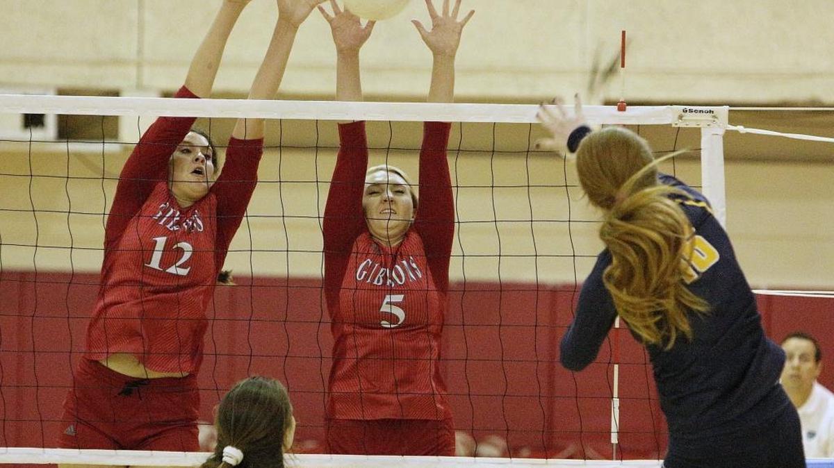 
Cardinal Gibbons’ Daniella Molinari (12) and Kara Otten (5) put up a double block against St. Thomas Aquinas’ Derry Costigan's (16) spike during their the BCAA Big 8 Volleyball tournament championship match Wednesday, Oct. 14, 2015 at Cardinal Gibbons High in Fort Lauderdale.

