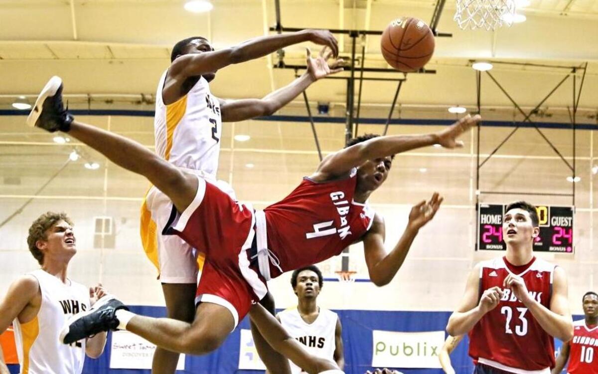 Winter Haven’s Dorian James, left, stops Cardinal Gibbons’ Ricardo James on a drive to the basket.