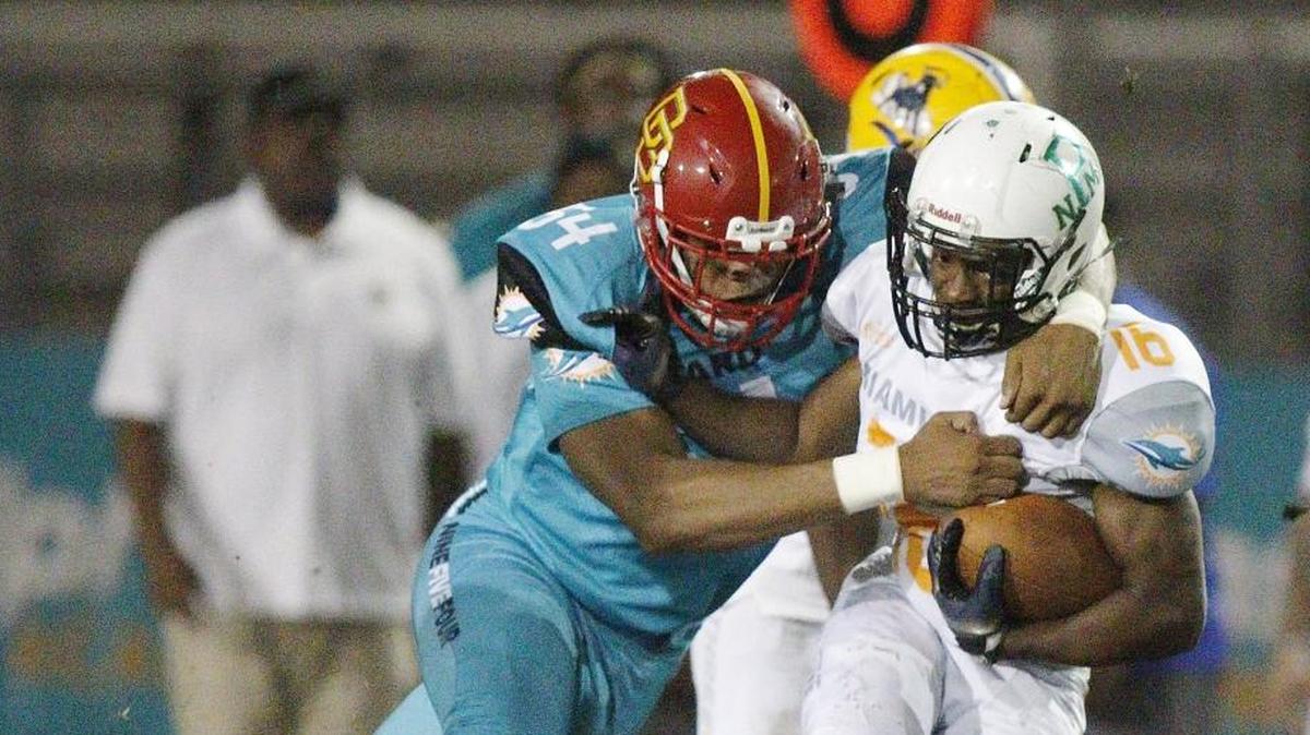 Broward’s Keldrick Hooks (54) tackles the Miami-Dade ball carrier during the All-Star game on Friday, Jan. 12, 2018, at Western High School in Davie.