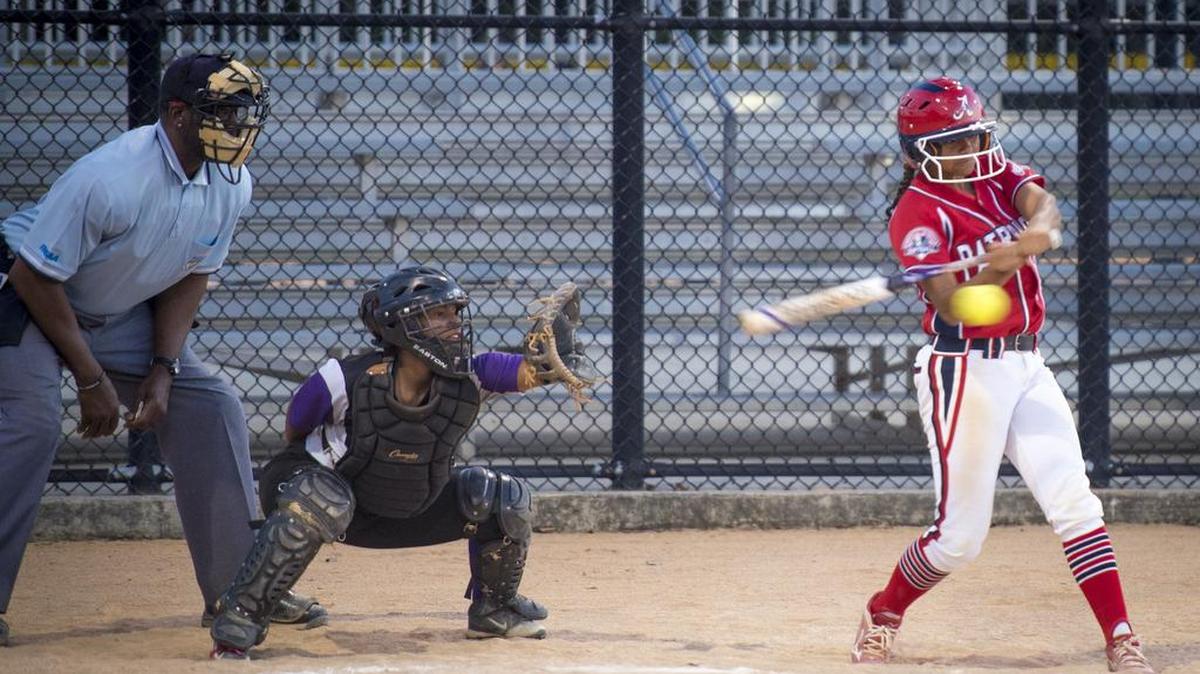 An American High softball player takes a swing during Tuesday night’s semifinal game at Palmetto Bay Park. The Patriots beat Southwest 18-0 to advance to the GMAC final for the first time in school history.