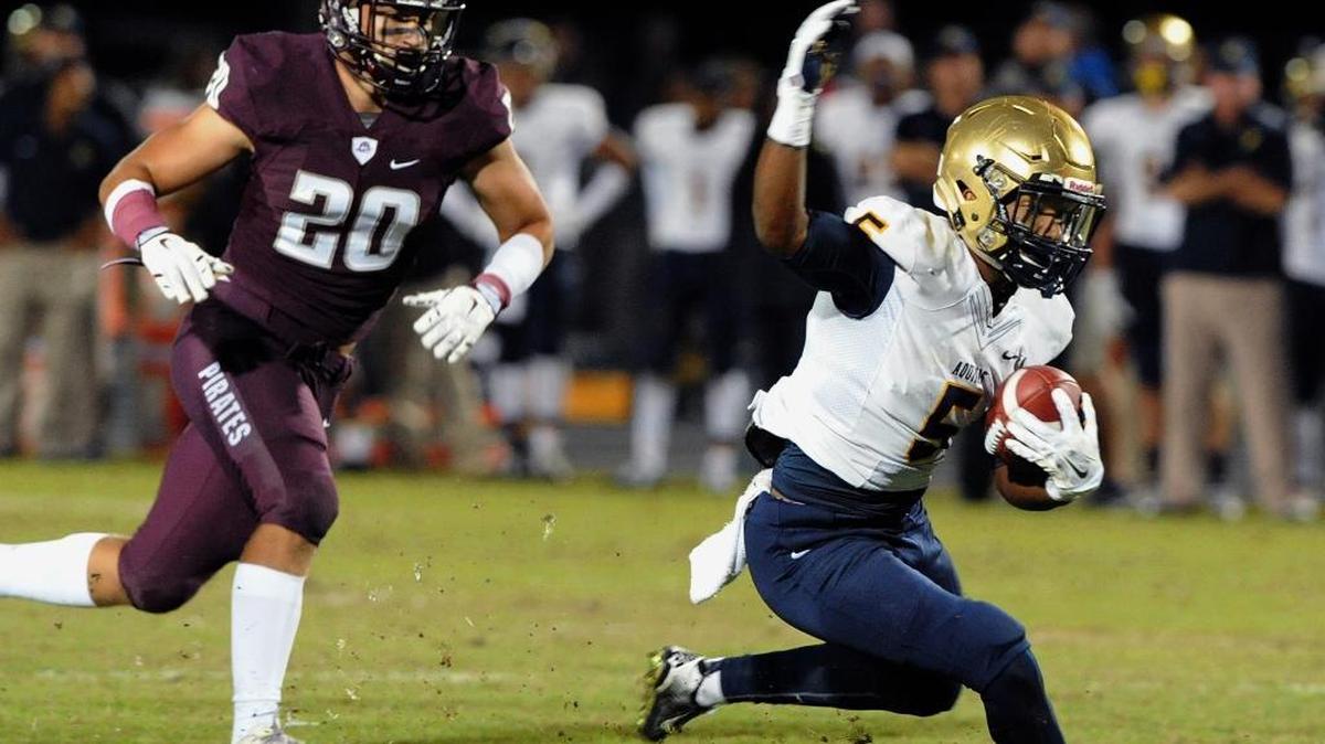 Jaxson Kincaide of St. Thomas Aquinas runs the ball as Braden River's Taylor Pawelkoski closes in during a Class 7A state semifinal game against Friday, Dec. 4, 2015 in Bradenton, Fla.