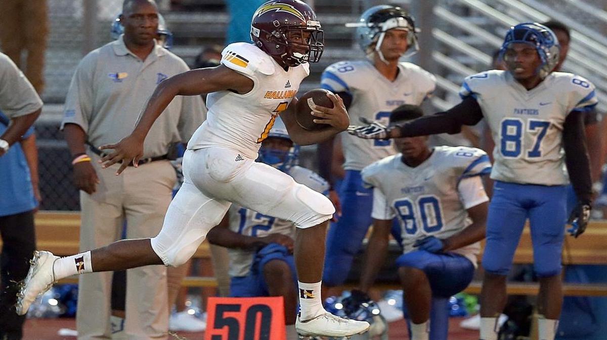 Hallandale’s Legend Moore runs for a gain against Dillard on Sept. 3, 2016. Moore was at it again on Saturday night, Oct. 1, 2016, when he executed a quarterback sneak late in the game to lift the Chargers to a come-from-behind victory against Jackson.