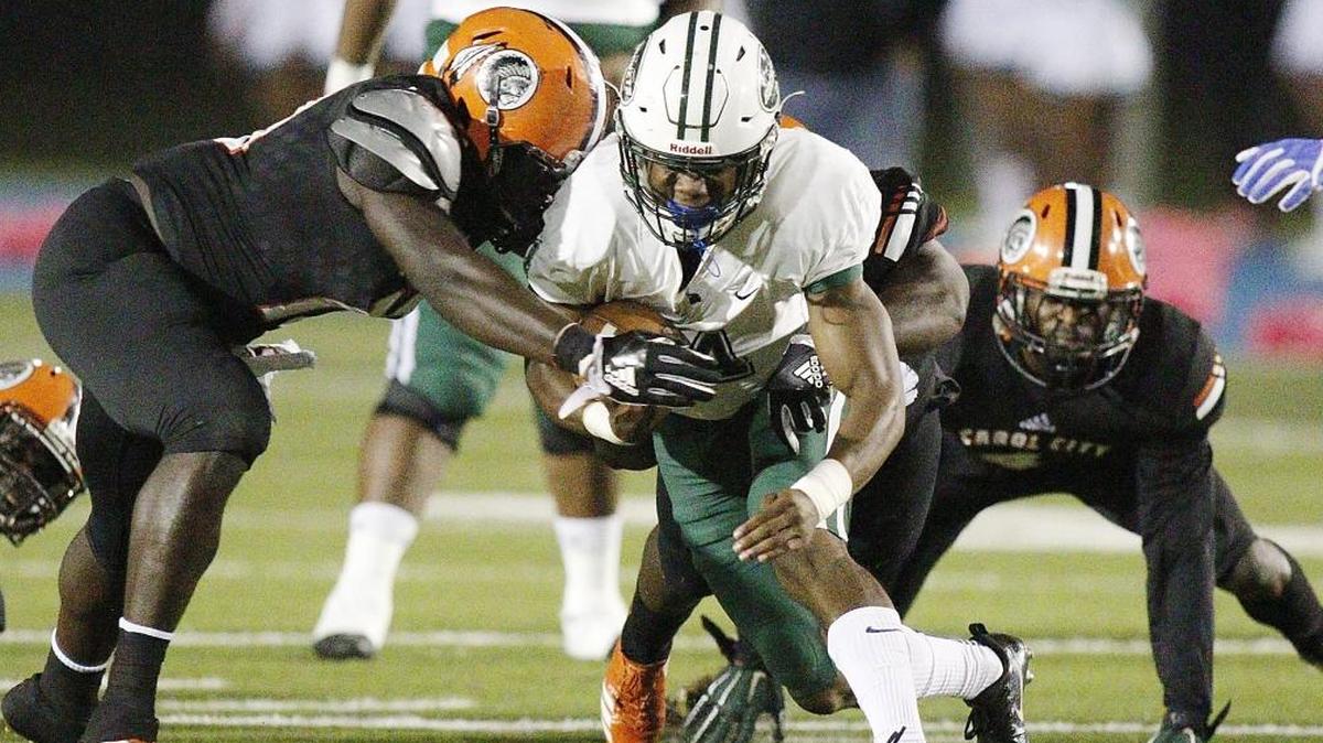 Miami Central Rockets' running back James Cook carries the ball against Carol City Chiefs during the football game on Fri., Oct. 27, 2017 at Traz Powell Stadium in Miami