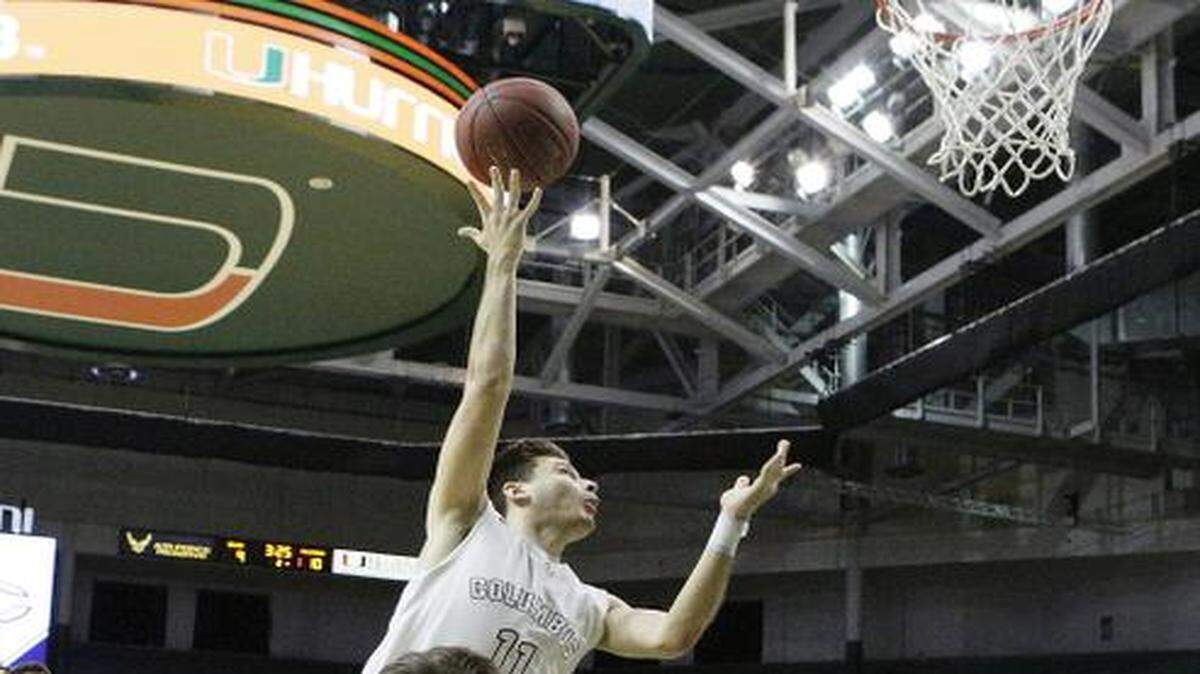 
Columbus’ Danny Rodriguez (11) attempts a shot against Belen during their basketball game Friday, Jan. 16, 2015, at BankUnited Center in Coral Gables

