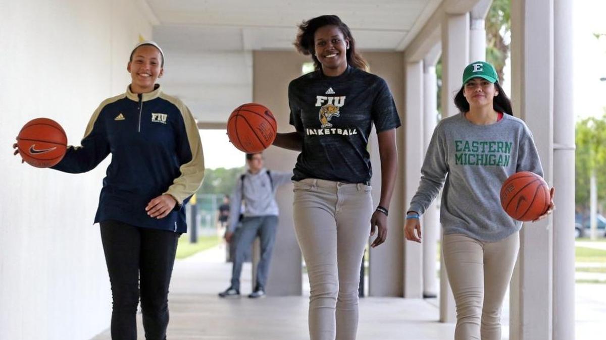 Ferguson girl’s basketball team members Sheslanie Laureano, 17, committed to FIU, Cheyanne Daniels, 17, committed to FIU, and Natalia Pineda, 17, committed to Eastern Michigan, in the hallway at Ferguson High School, Nov. 29, 2017.
