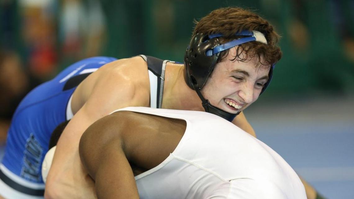 Brevin Balmeceda, top, from South Dade, wrestles against Johnny Lovett, from Southridge, during a 145 division GMAC wrestling championship match at Ronald W. Reagan Doral Senior High School on Feb. 4, 2017. Balmeceda won the match.