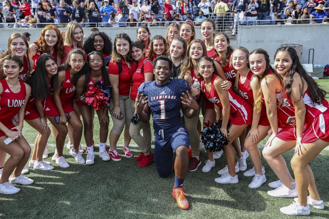 Chaminades Keontra Smith (1) poses with cheerleaders after Chaminade-Madonna Lions defeats King’s Academy during the Florida High School Athletic Association Class 3A State Championship at Camping World Stadium in Orlando on Friday, December 7, 2018.