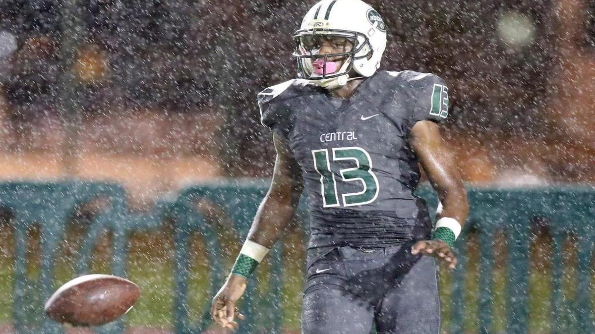 Miami Central receiver Kahmanie Carter walks in the rain after scoring a touchdown against Naples in a state semifinal game Friday, Dec. 4, 2015 at Traz Powell Stadium in Miami.