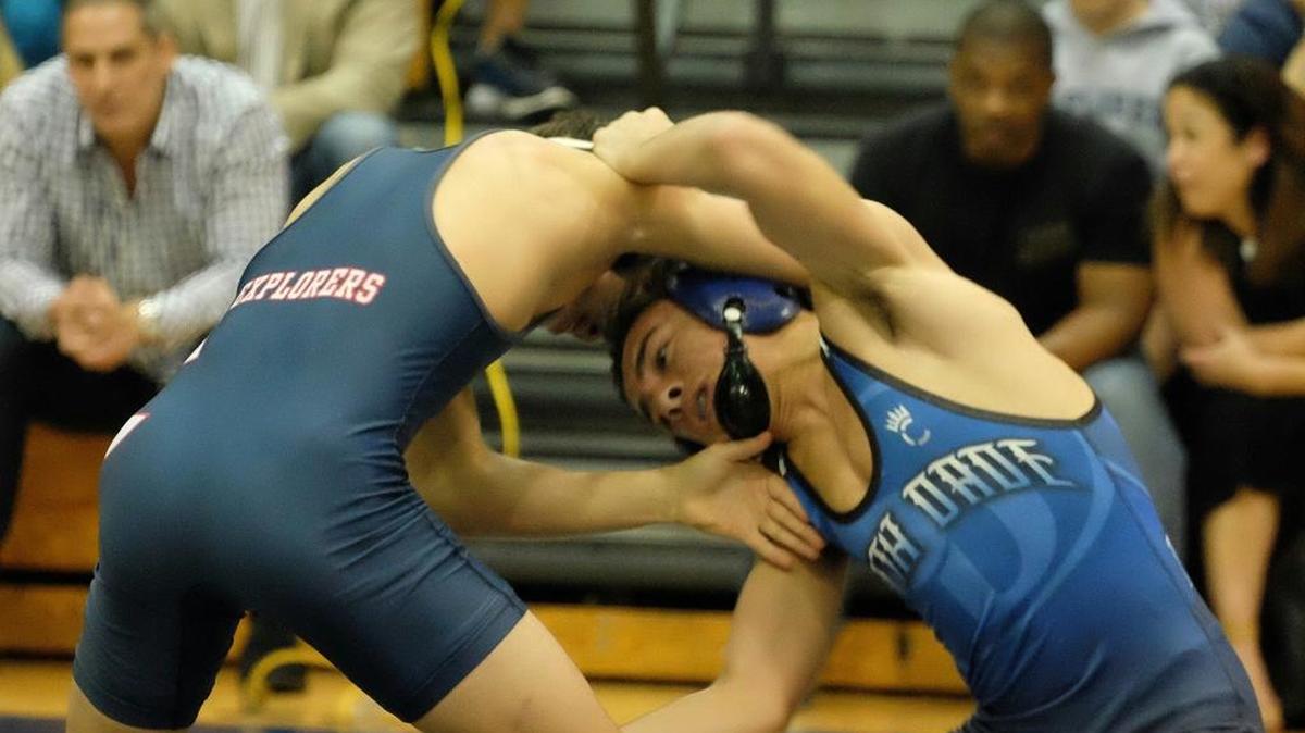 Columbus’ Edgard Martinez, left, takes on Taylor Orta of South Dade in a wrestling match Wednesday, Jan. 27, 2016.