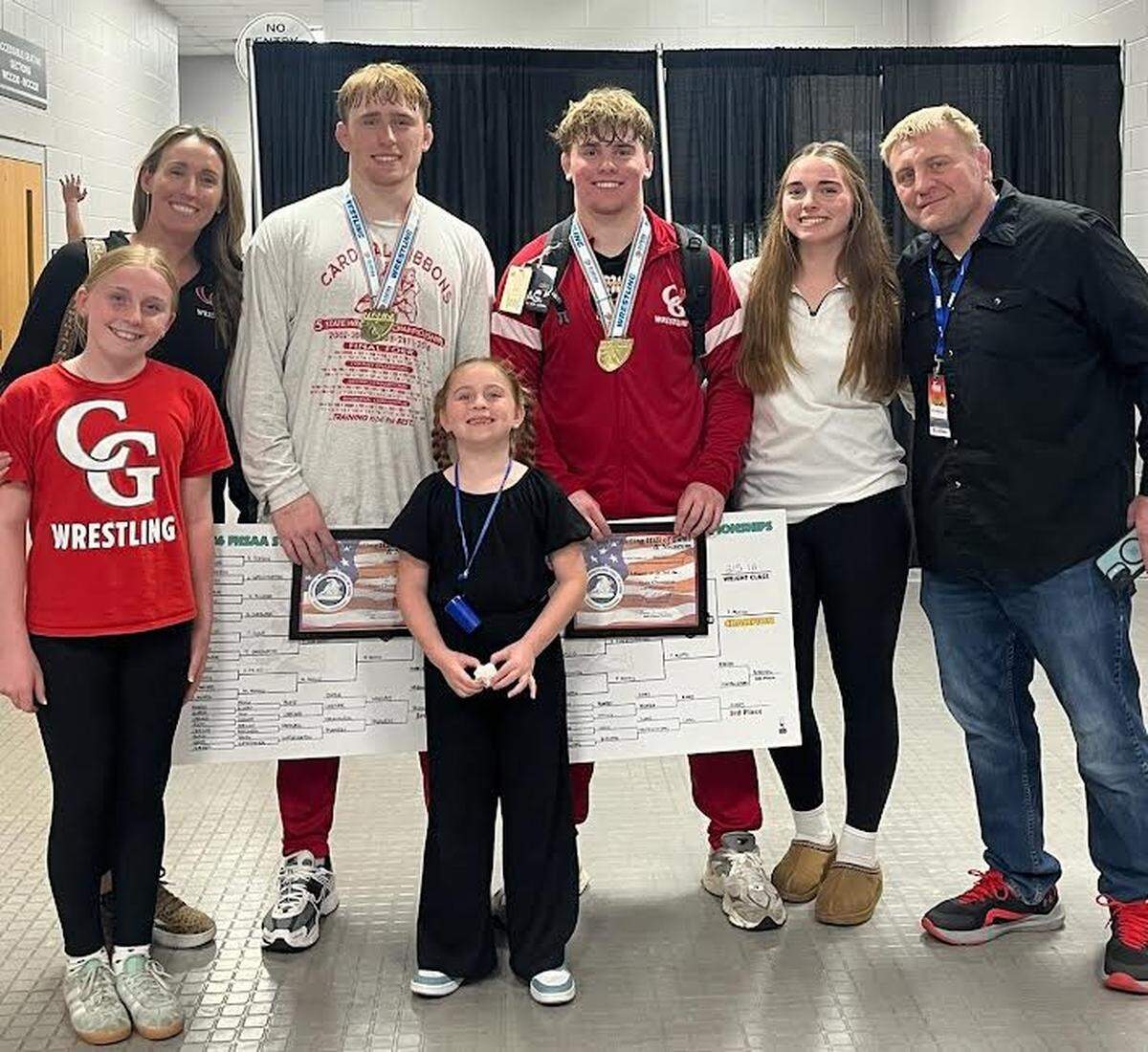 The Mocco brothers (Michael and Peter) with their family after winning state titles to complete undefeated seasons -- combining on a 117-0 mark.