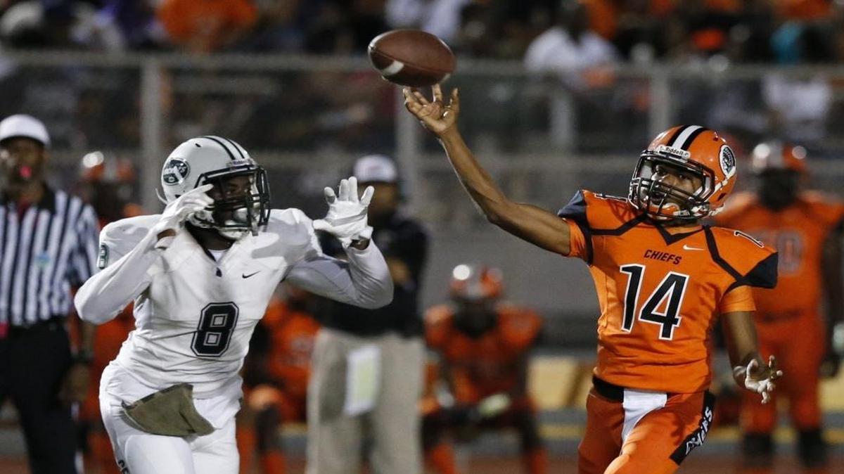 
Carol City's quarterback Lorenzo Floyd, (14), releases the ball in the half as Central's Eric Mitchell, (8), defends during game between Carol City High School vs Miami Central High School at Traz Powell Stadium on Saturday, October 3, 2015.
